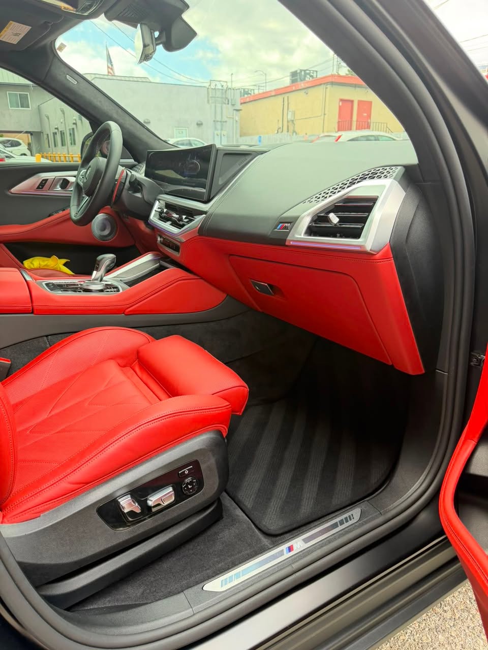 Red leather BMW interior cleaned and conditioned during interior detailing